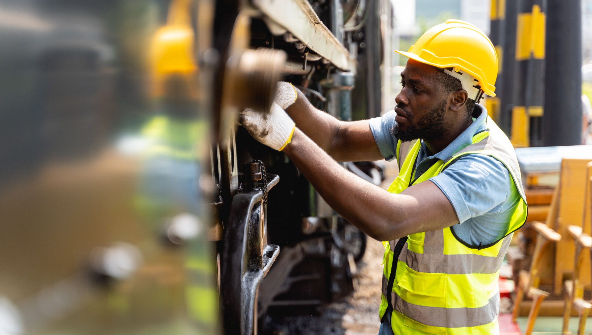Professional engineers in safe work clothes He's checking the big machines with intention. Workers are looking at parts of the machine and inspecting with skill in industrial worker concept.